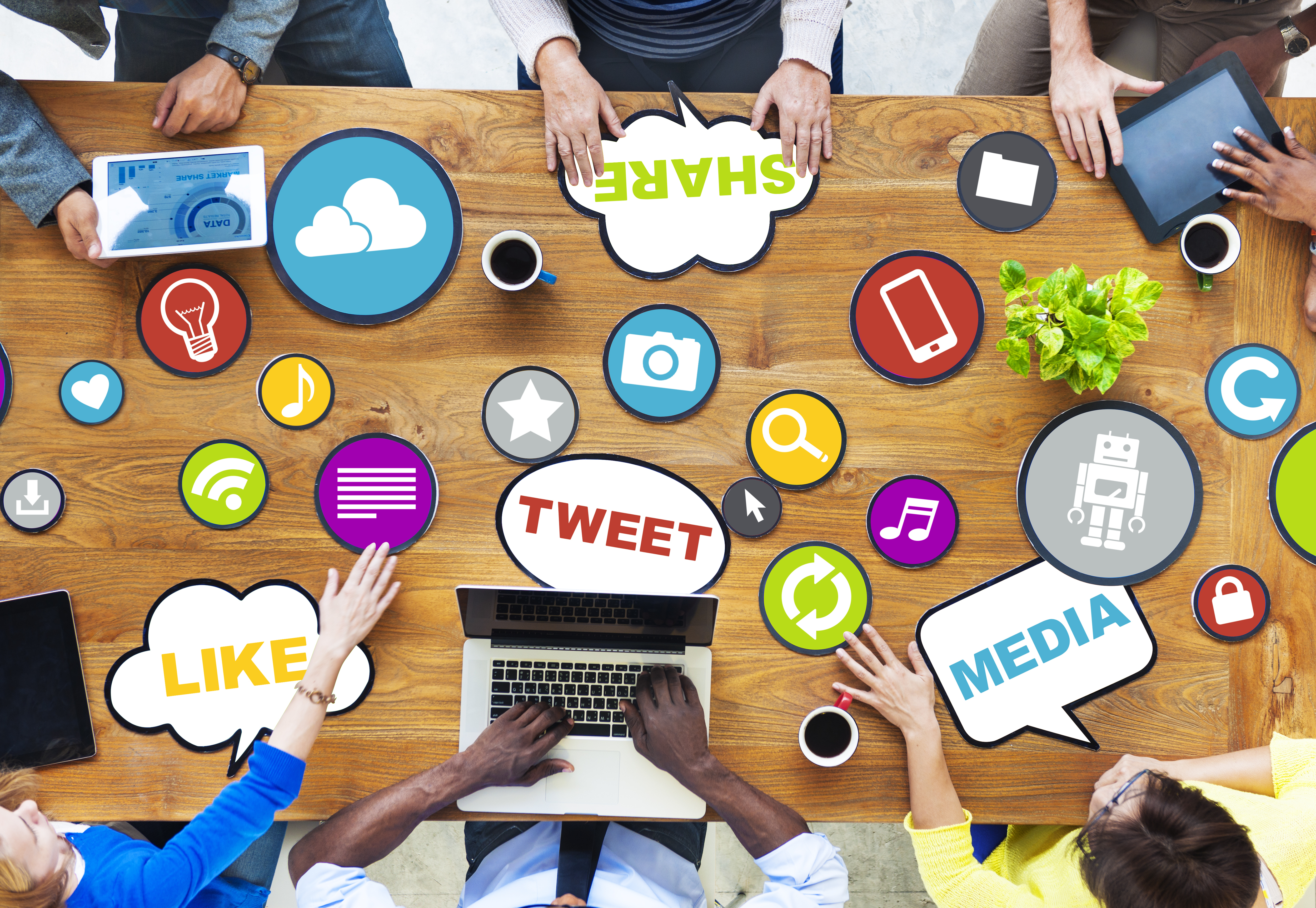 Conference table with people discussing social media tools